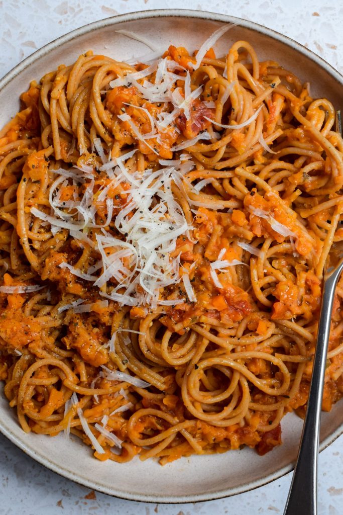 Close up of a bowl of red lentil pasta.