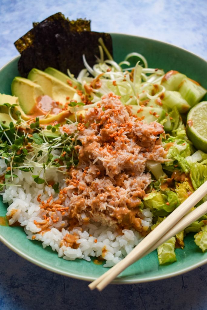 Rice bowl with fresh crab drizzled with creamy yogurt dressing.