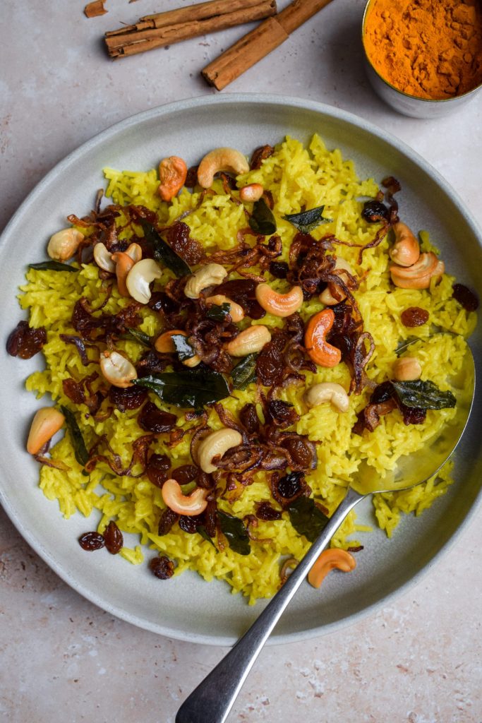 Sri Lankan Yellow Rice topped with a crispy garnish.