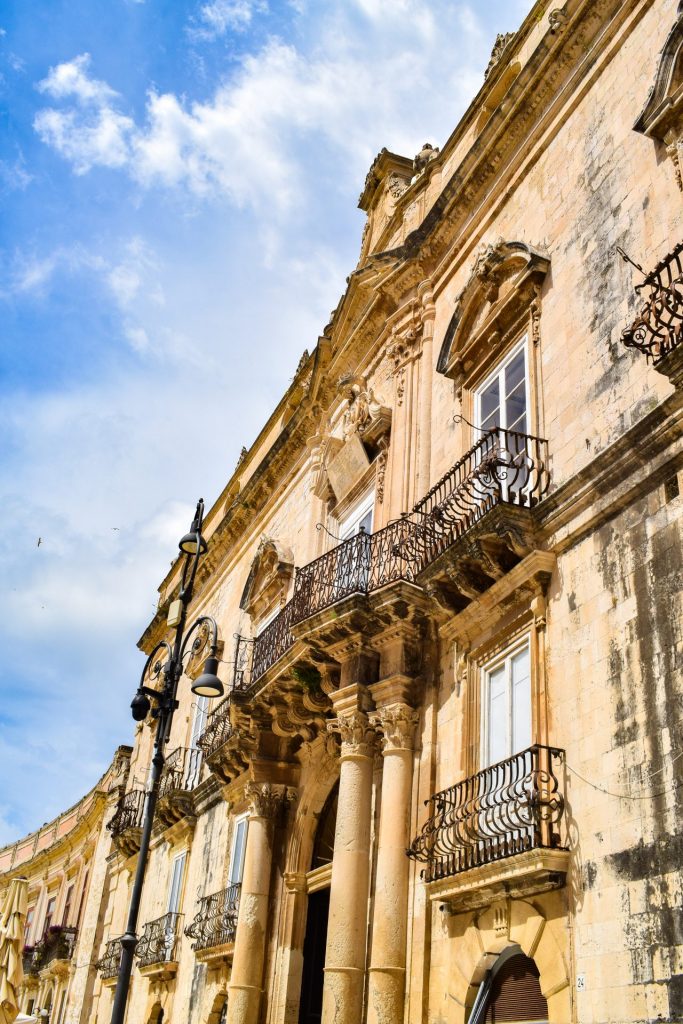 Facade of yellow stone houses in Ortigia.