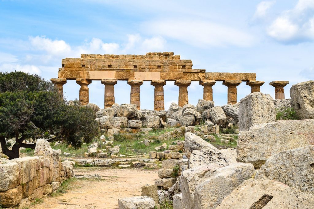 Temple ruins against a blue sky at the Selinunte agricultural park.