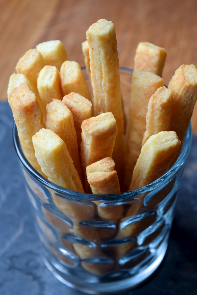Cheese straws standing up in a drinking glass.