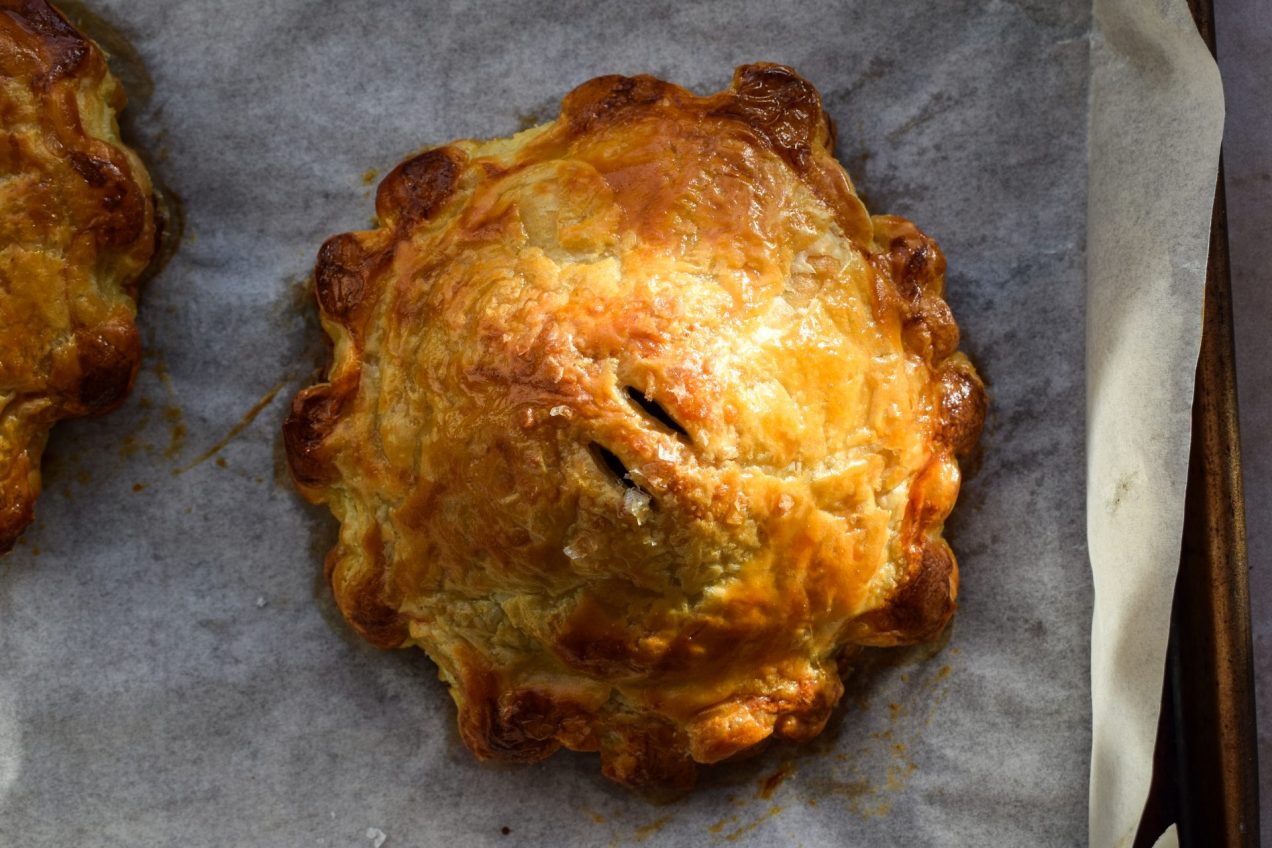 Single serving mushroom wellington on a baking sheet in sunlight.