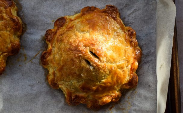 Single serving mushroom wellington on a baking sheet in sunlight.
