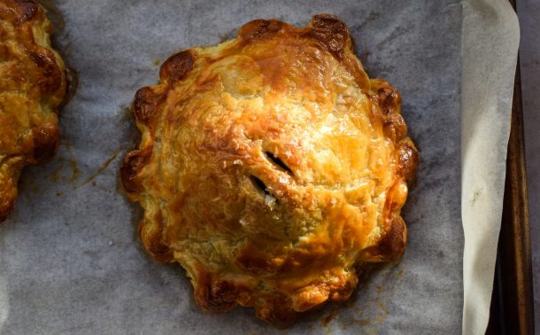 Single serving mushroom wellington on a baking sheet in sunlight.