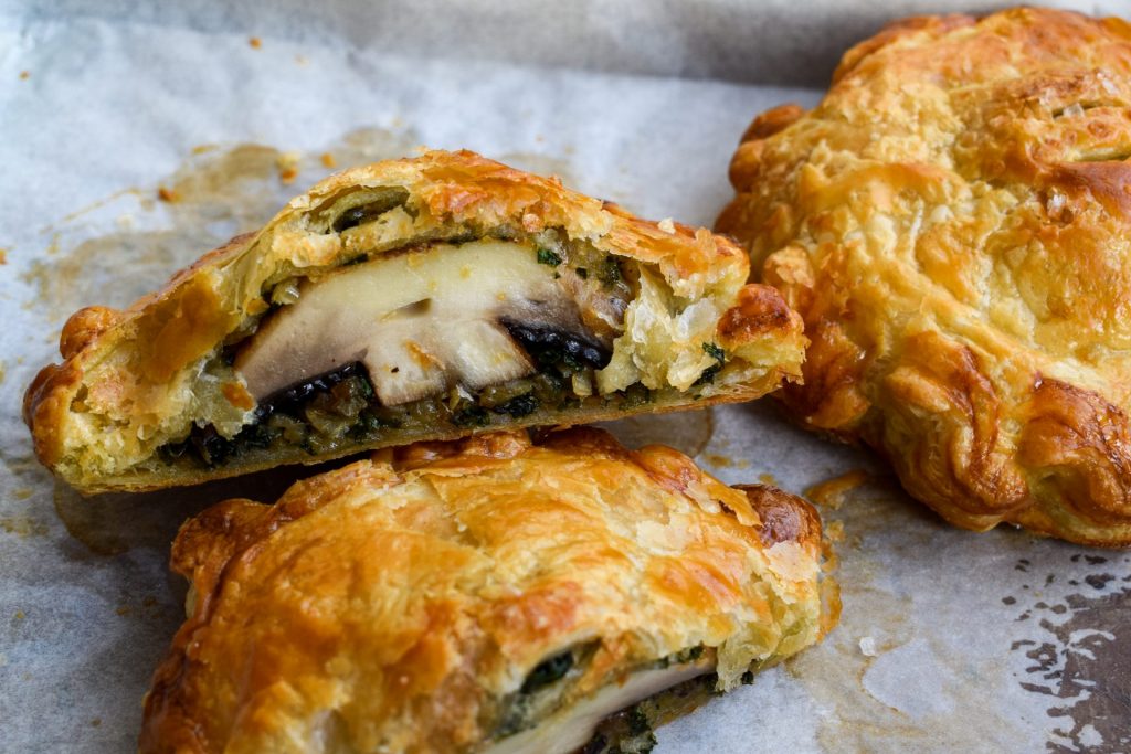 Close up of a portobello mushroom wellington cut in half.