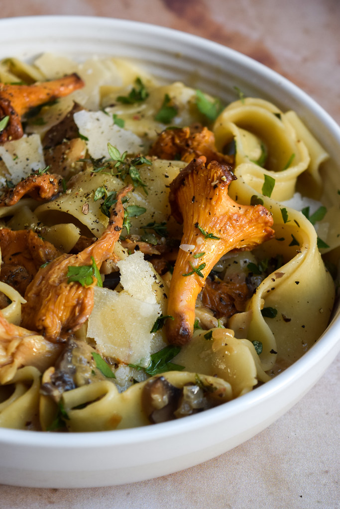 Close up of a griolle mushroom on a bowl of mushroom pasta.
