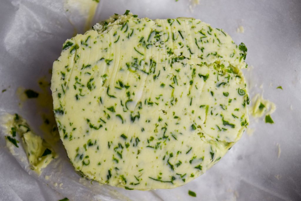 Close up of a slice of wild garlic butter.