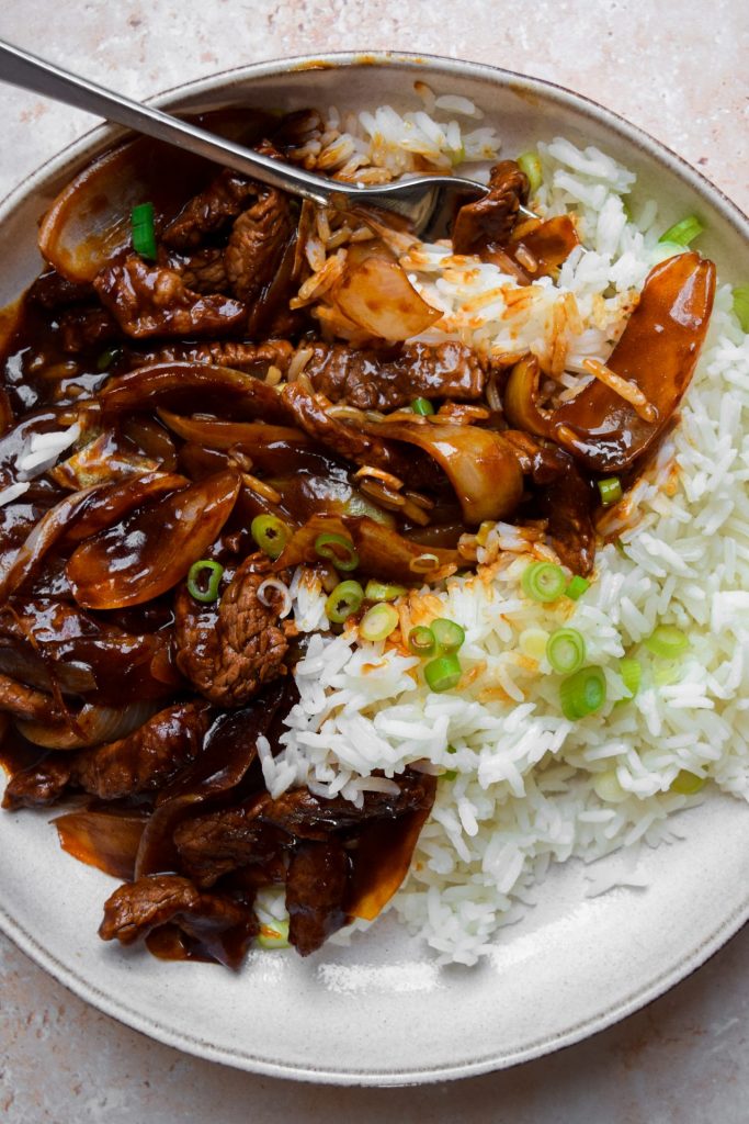 Beef and onion stir fry with rice.