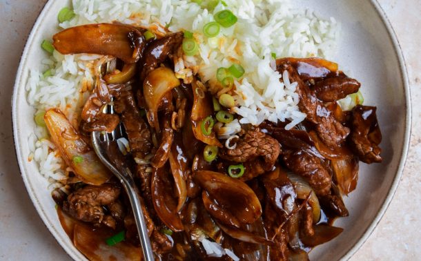 Close up of Chinese beef and onion with jasmine rice.