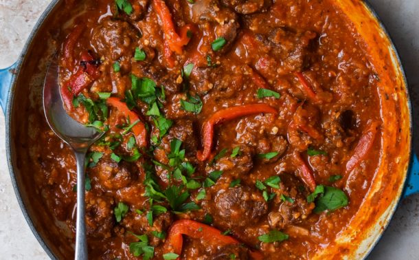 Close up of a Spanish lamb neck stew with red peppers.