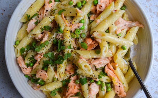 Close up of a bow of salmon pea pasta.