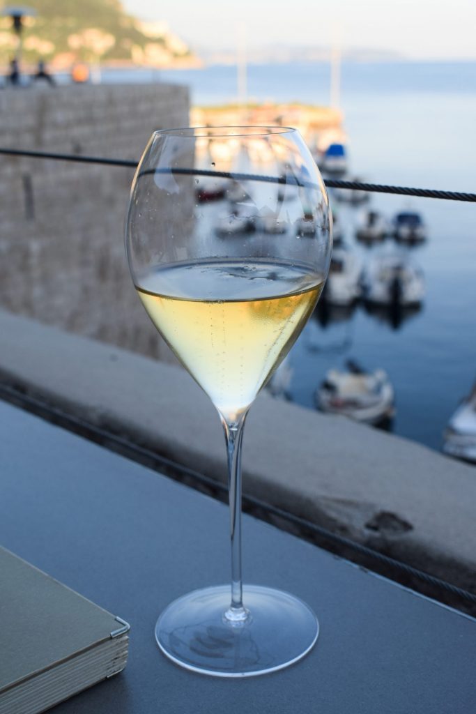 Croatian sparkling wine against the view of the Old Harbour from 360 Dubrovnik