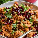 Close up of a bulgur wheat salad with parsley and pomegranate.