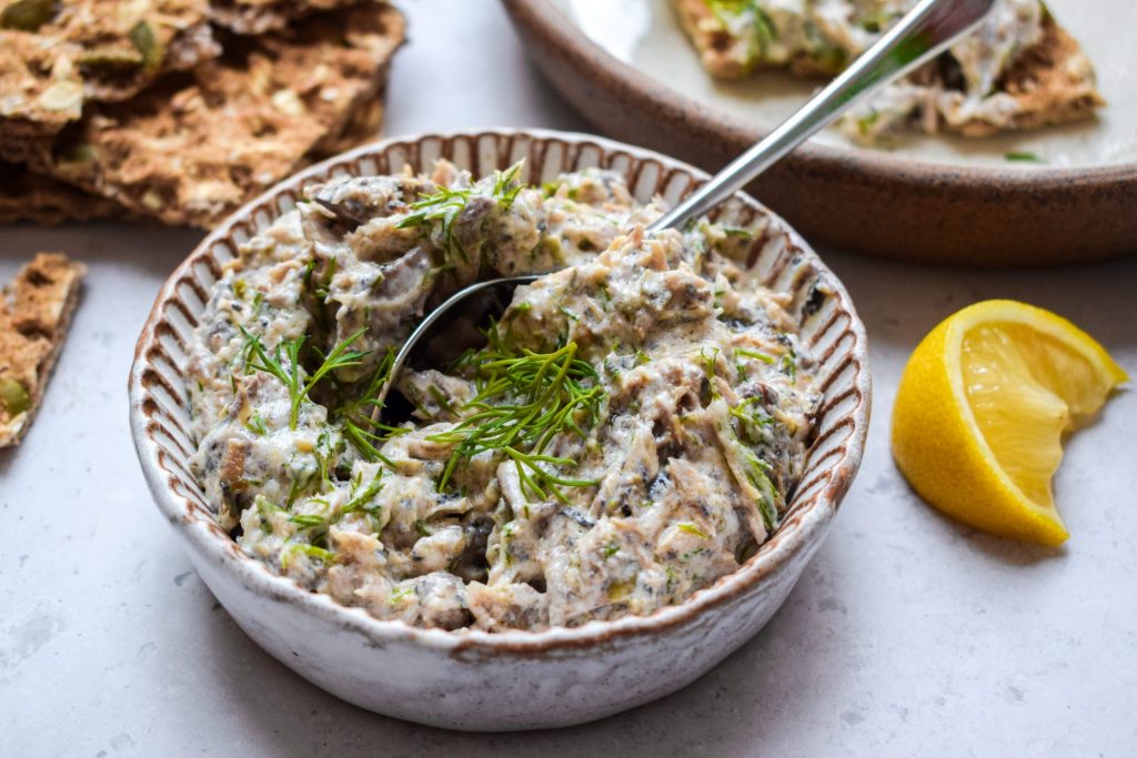 White bowl of mackerel pate topped with fresh dill.