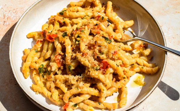 Bowl of pasta with Pesto alla Trapanese topped with toasted breadcrumbs.