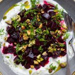 Close up of a bowl of whipped feta piled up with cubed beetroot.