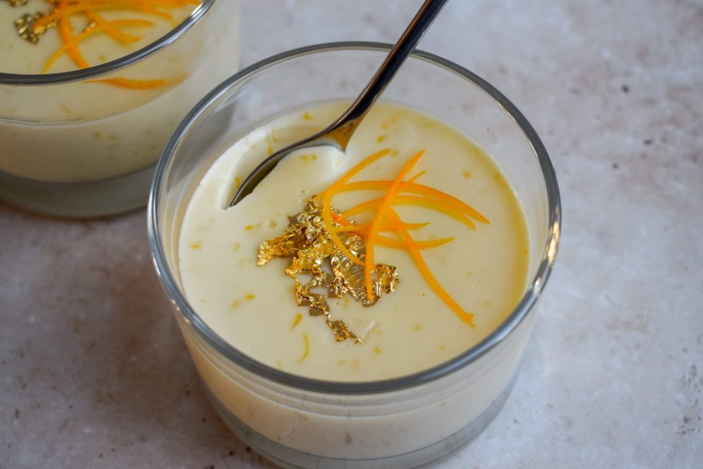 Clementine Panna Cotta topped with gold leaf and shredded clementine peel.