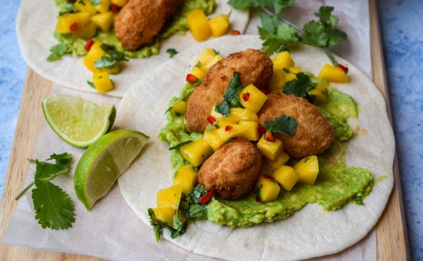 Close up of a taco with scampi, mango and avocado.