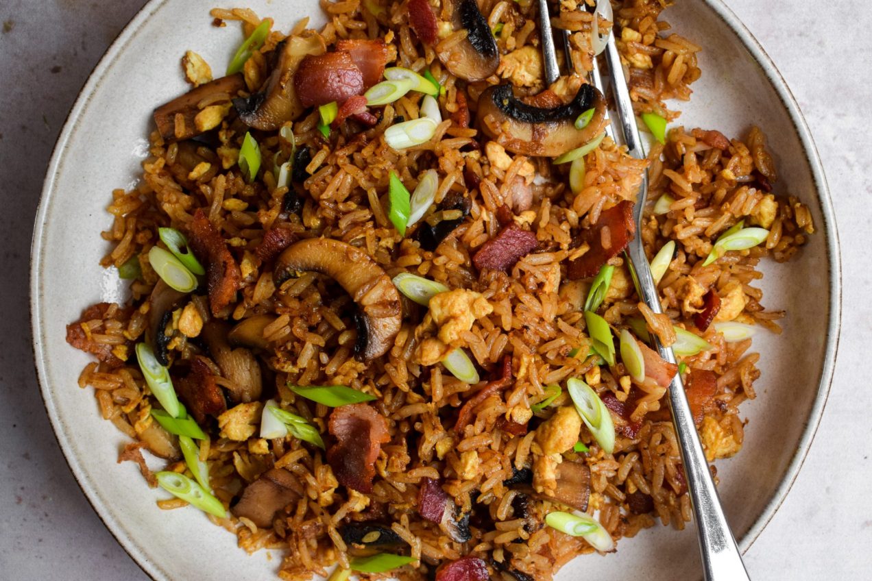 Close up of fried rice with bacon and mushrooms.