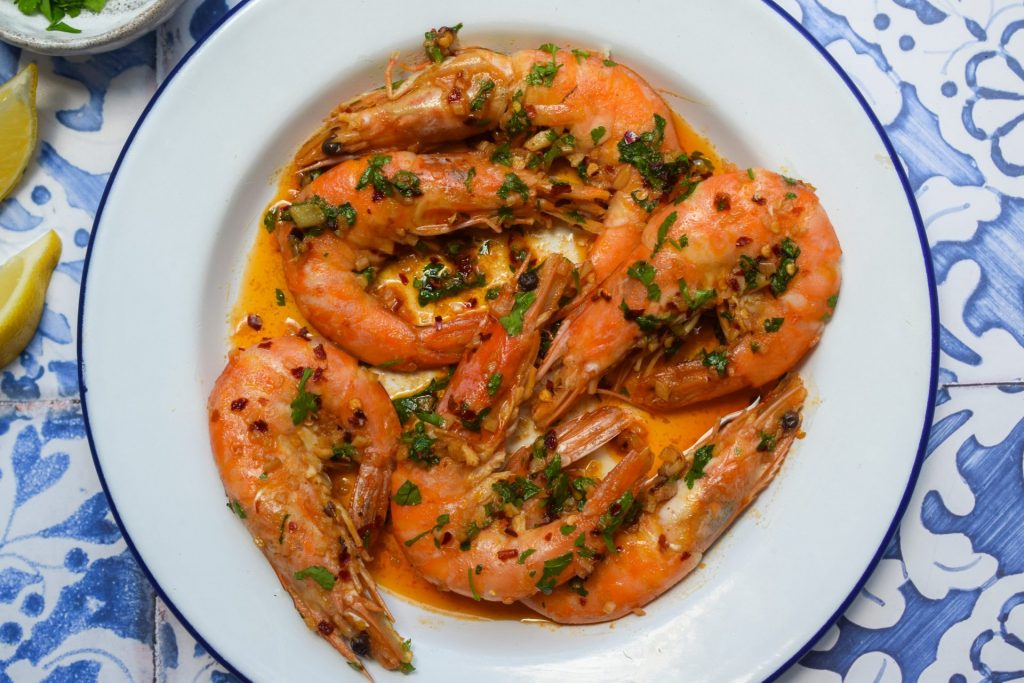 Pil Pil Prawns on a blue and white plate.