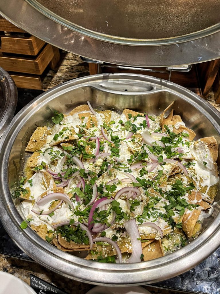 Catering dish of chilaquiles in green sauce.