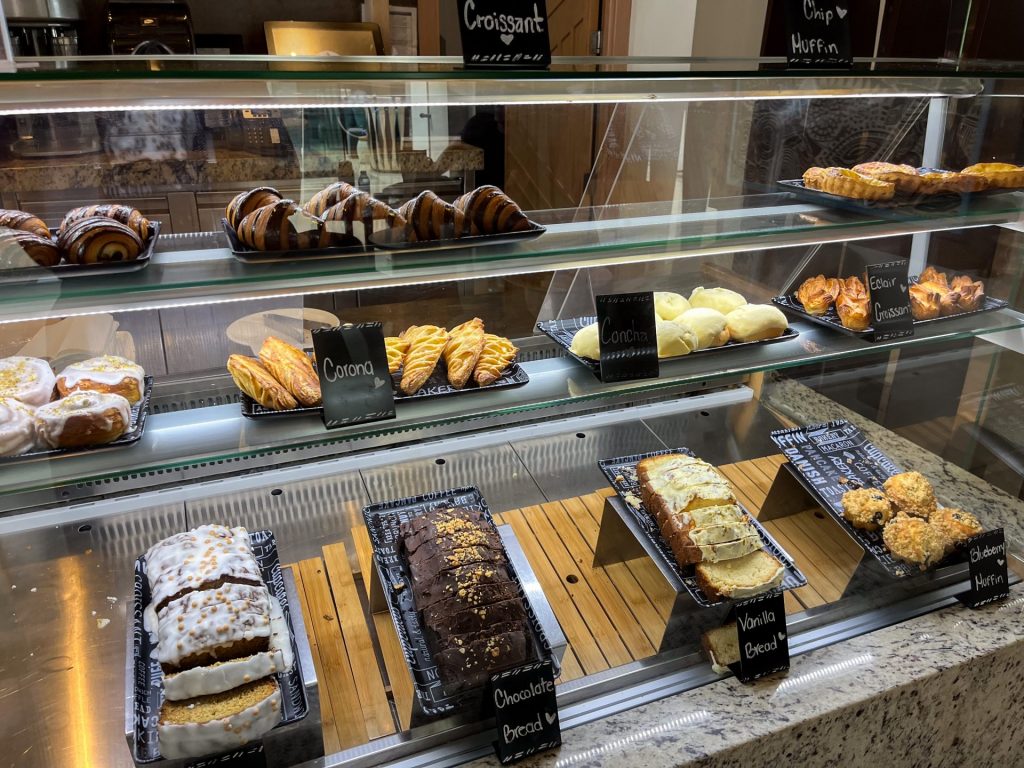 Cakes and pastries in a glass display case.