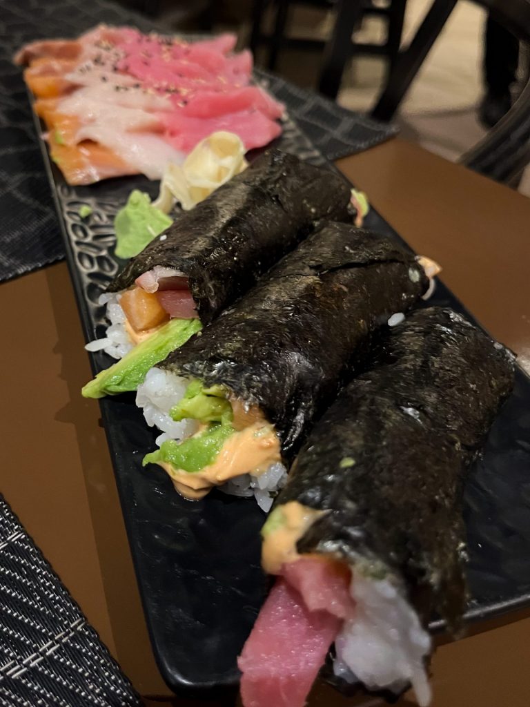 Platter of sushi hand rolls and sashimi.