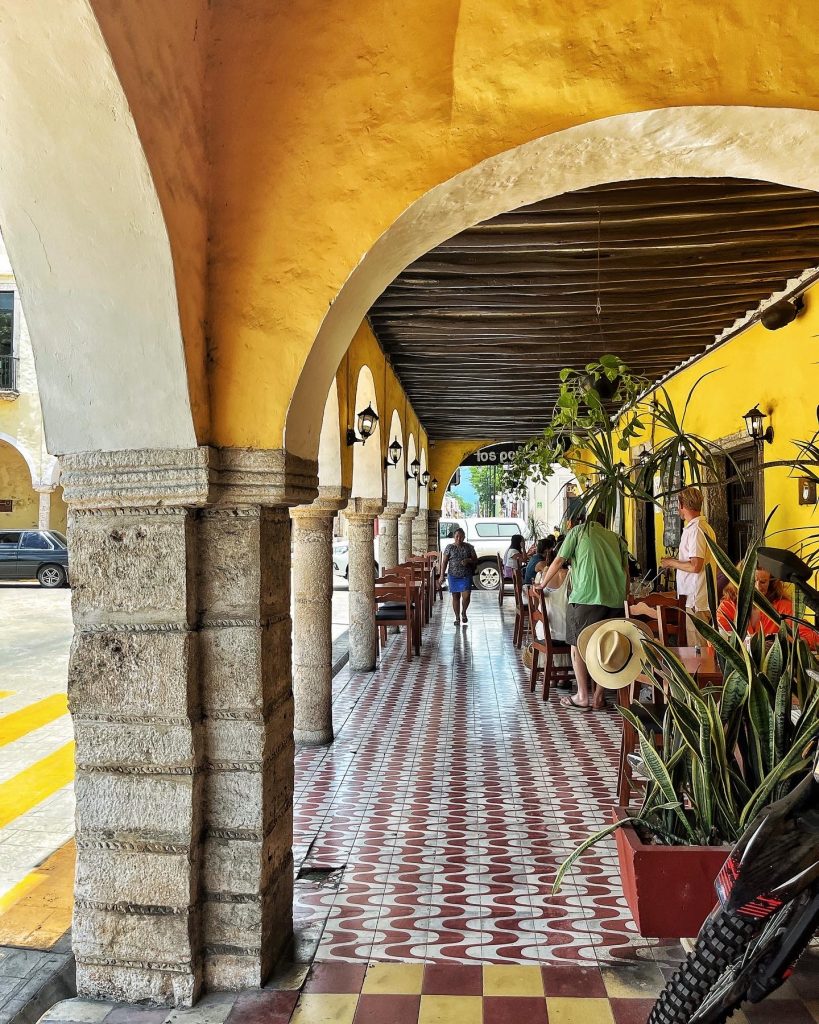 Bright yellow painted colonnade in Valladolid, Yucatan.