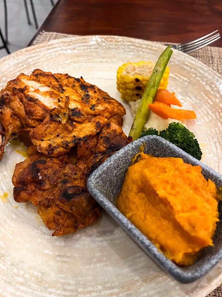 Mexican grilled chicken with a bowl of sweet potato mash.