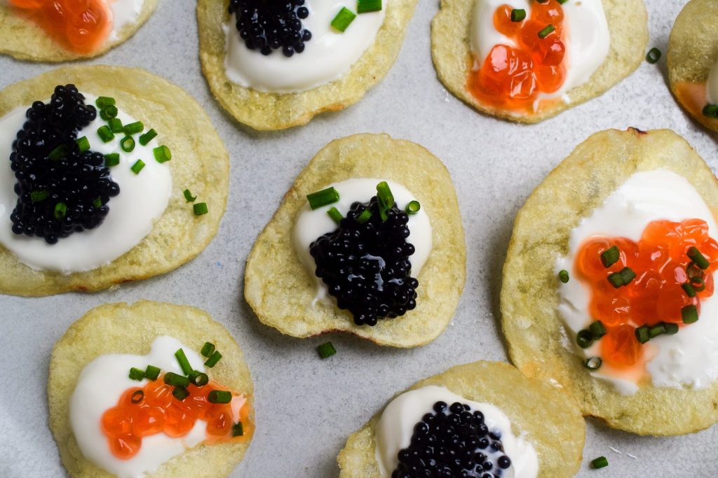 Close up of crisps topped with lumpfish and trout caviar.