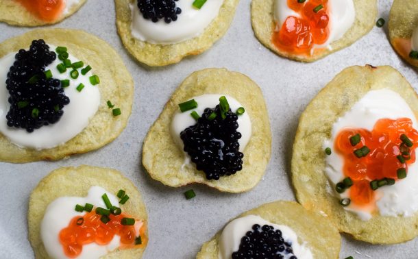 Close up of crisps topped with lumpfish and trout caviar.