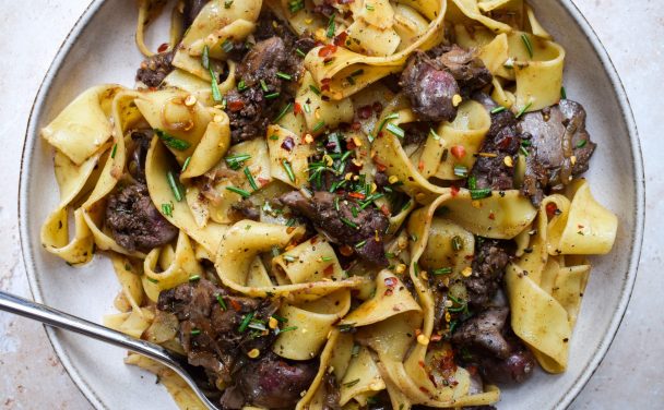 Chicken Liver Pappardelle close up with chopped rosemary and chilli flakes
