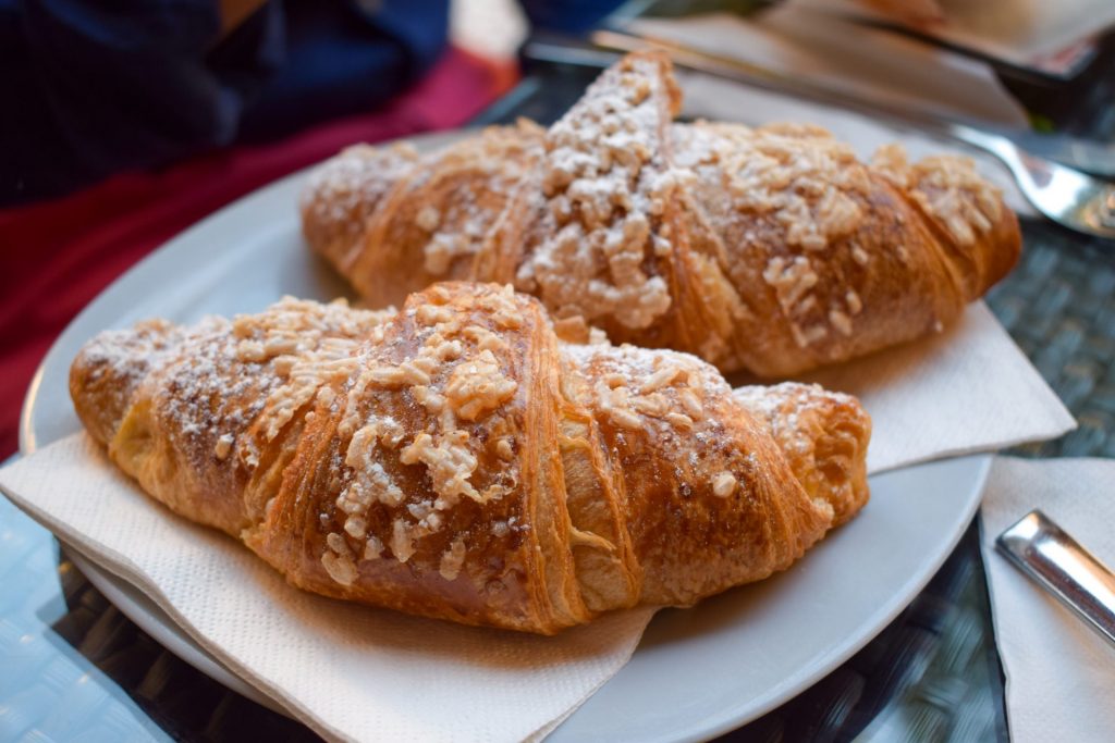 Cream filled croissants on a grey plate.