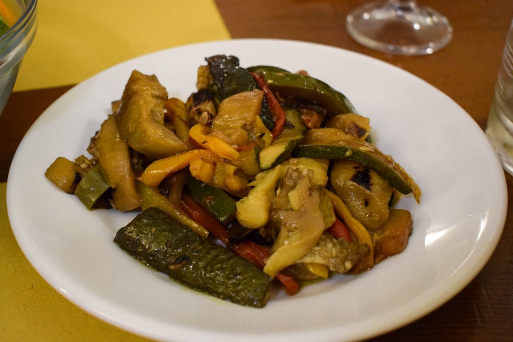 Slow cooked peppers, aubergines and courgettes on a white plate