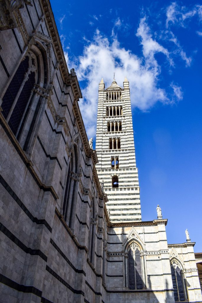 The striped black and white marble tower of Siena Cathedral.