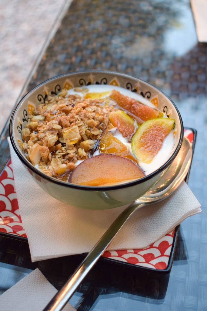 Bowl of yogurt with granola, figs and plums