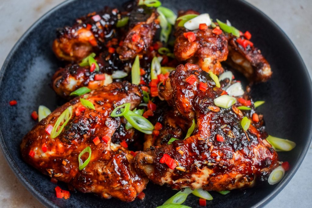 Chicken wings scattered with chopped chilli and spring onion.