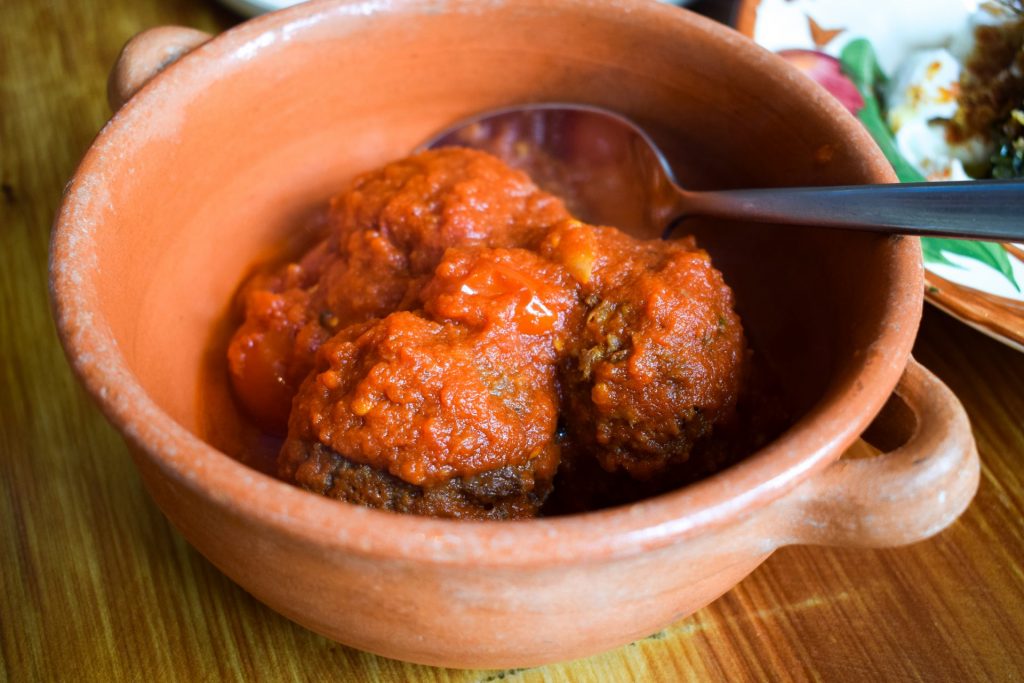 Bowl of bread meatballs in tomato sauce.