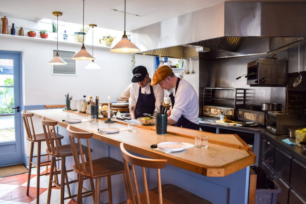 Chefs cooking in the open kitchen at The Blue Pelican in Deal.