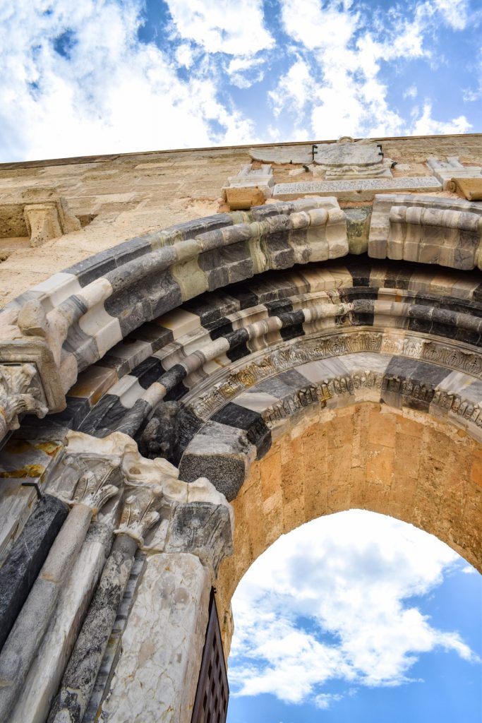 Close up of the restored stone entrance archway of the Norman Fortress in Ortigia.