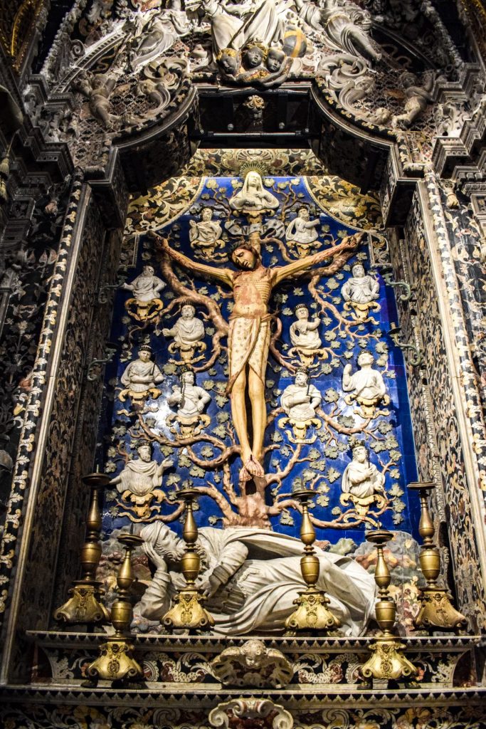 Christ on a cross against a dark blue background of an alter piece in Monreale Cathedral