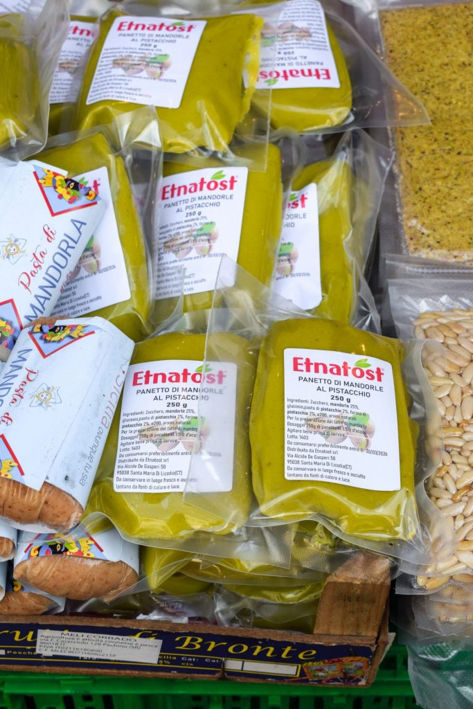 Close up of packets of pistachio paste on a market stall.