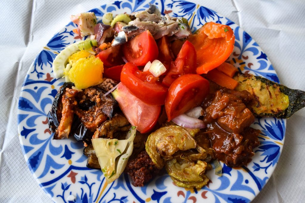 Blue and white plate of mixed Sicilian salads