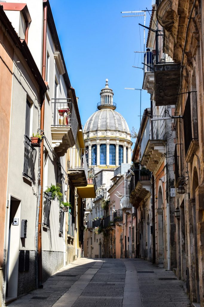 The dome of Duomo di San Giorgio viewed through Ragusa's side streets.