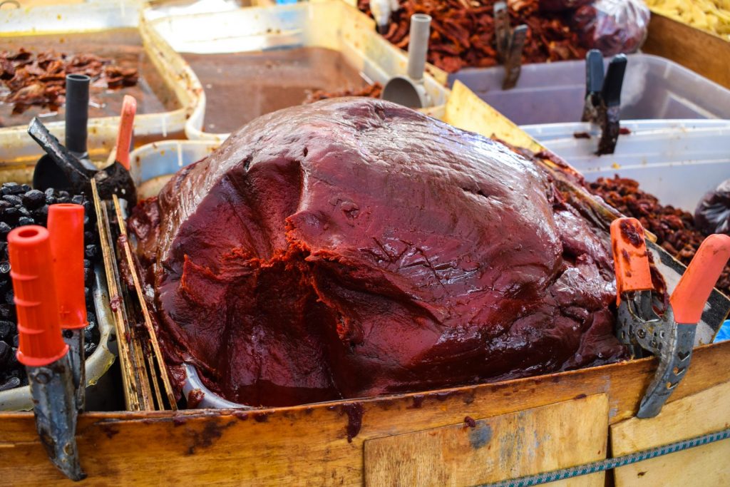 Giant pile of sundried tomato paste on a market stall.