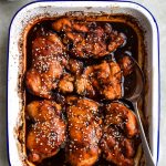 Blue and white tin of honey soy chicken with a serving spoon in the side.