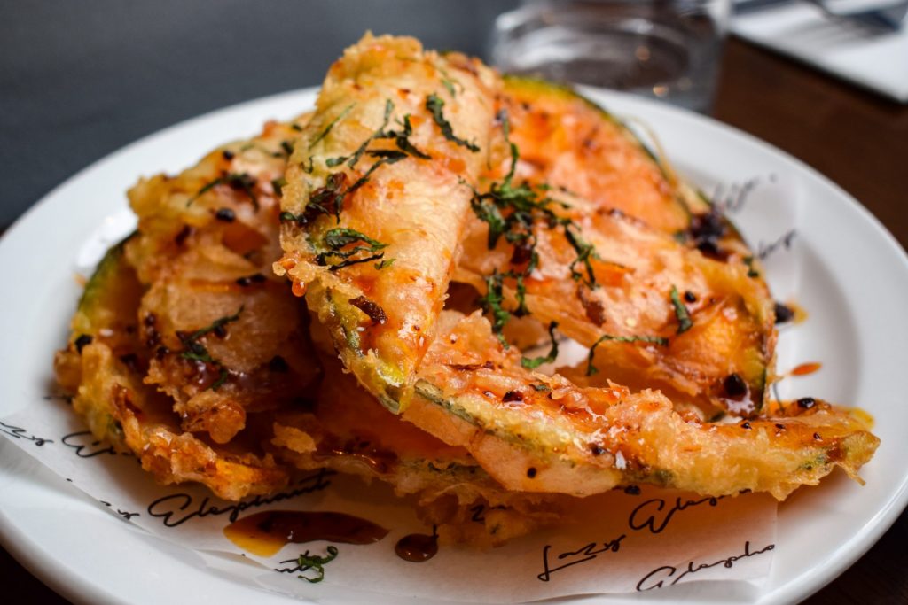 Plate of crown prince fritti topped with hot honey and shredded mint.