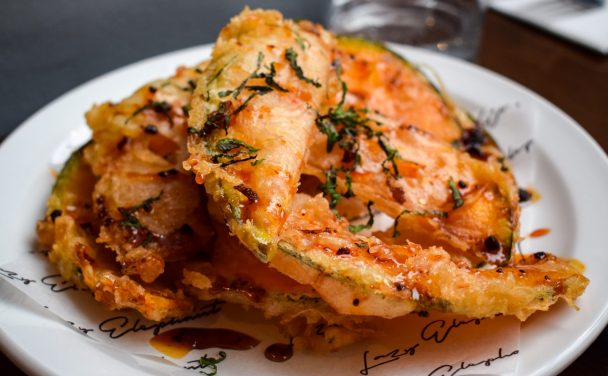 Plate of crown prince fritti topped with hot honey and shredded mint.