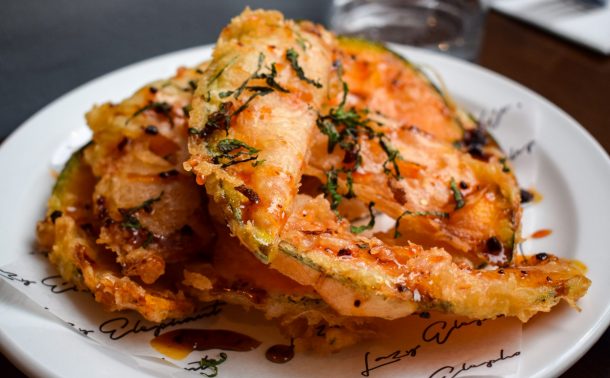 Plate of crown prince fritti topped with hot honey and shredded mint.